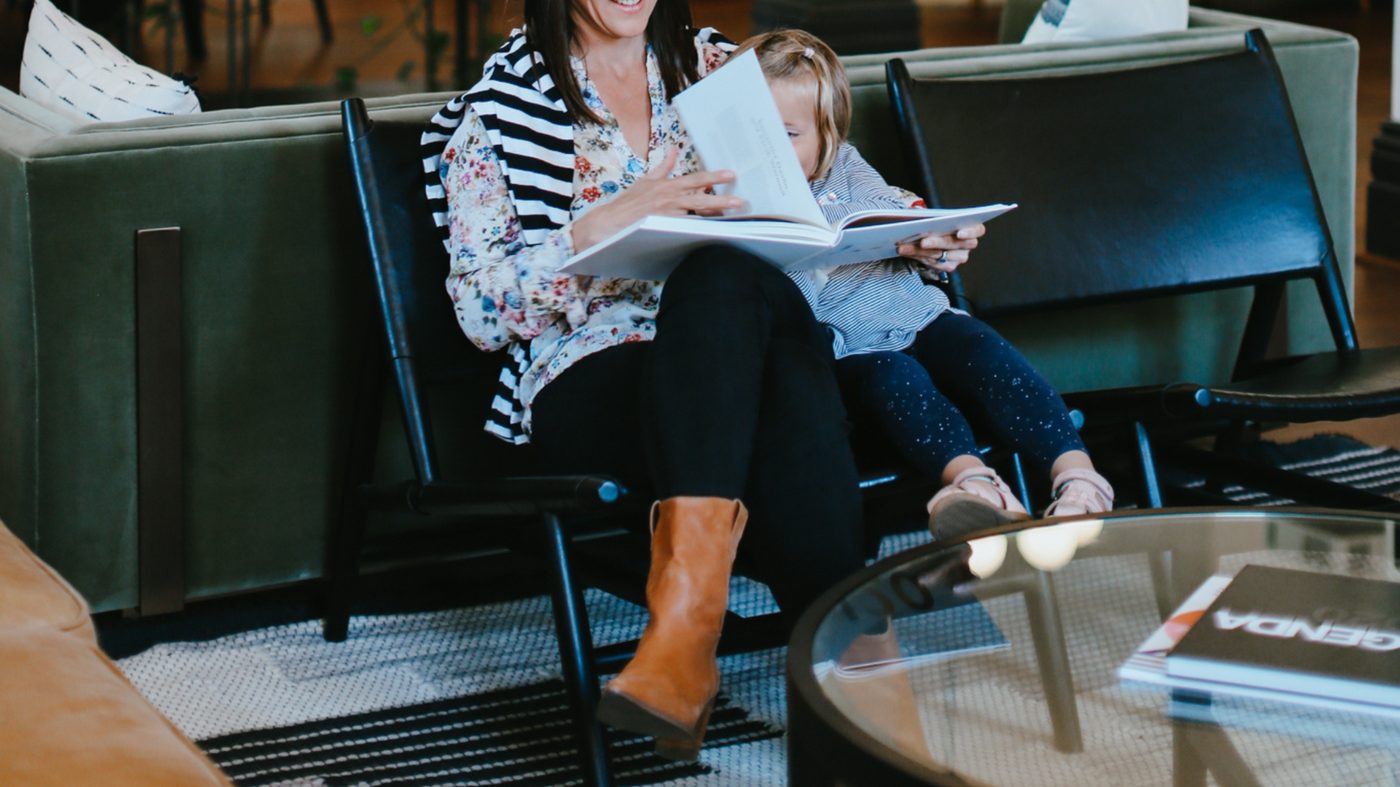 A mother and child sharing a book together